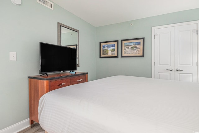 201 S Ocean Blvd Unit 1112, Myrtle Beach, SC 29577 - bedroom with baseboards, light wood-type flooring, and a closet