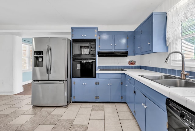 3001 Wiley Dr, North Myrtle Beach, SC 29582 - kitchen featuring black appliances, blue cabinets, a sink, and healthy amount of natural light