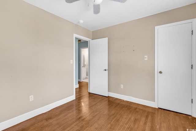 3001 Wiley Dr, North Myrtle Beach, SC 29582 - unfurnished bedroom with baseboards, wood finished floors, and a ceiling fan