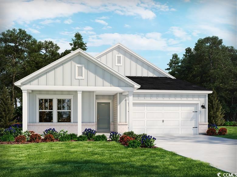4849 Hopespring St, Myrtle Beach, SC 29579 - view of front facade with board and batten siding, an attached garage, driveway, brick siding, and a front lawn