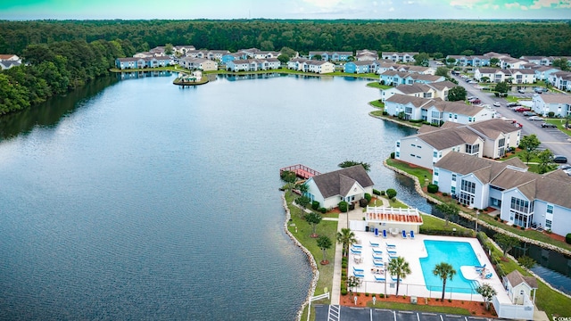 8925 Duckview Dr Unit A, Surfside Beach, SC 29575 - aerial view of a pool area, a large body of water, and a heavily wooded area