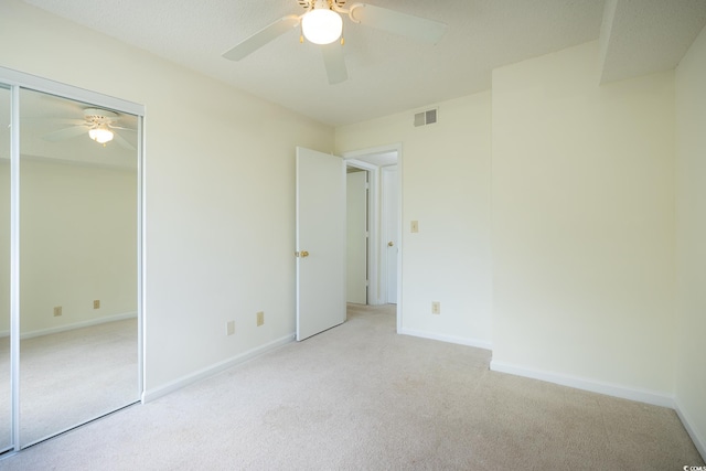 8925 Duckview Dr Unit A, Surfside Beach, SC 29575 - unfurnished bedroom with light colored carpet, baseboards, a ceiling fan, and a closet