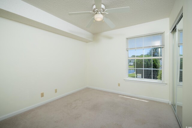 8925 Duckview Dr Unit A, Surfside Beach, SC 29575 - empty room with light carpet, a textured ceiling, baseboards, and a ceiling fan