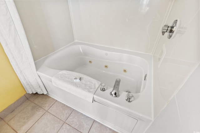 full bathroom with tile patterned floors and a tub with jets