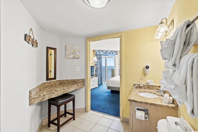 bathroom with vanity, ensuite bath, baseboards, and tile patterned flooring