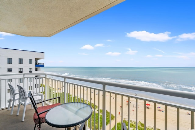 balcony with view of water and beach