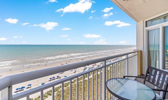 balcony featuring view of water and beach