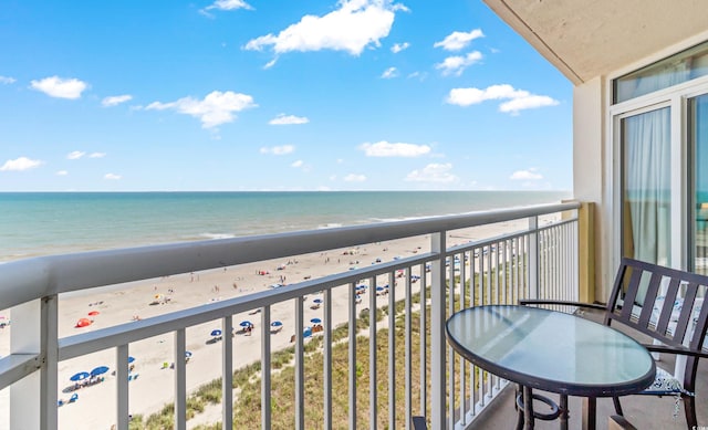 balcony featuring view of water and beach