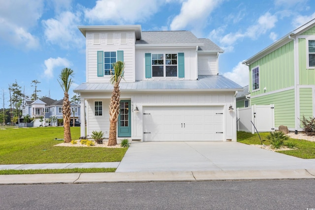 1929 Indigo Cove Ln, Calabash, NC 28467 - view of front facade featuring an attached garage, driveway, board and batten siding, and metal roof