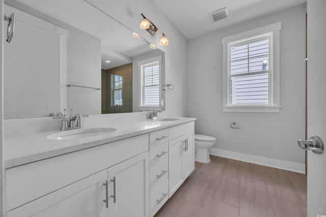 1961 Indigo Cove Ln, Calabash, NC 28467 - full bathroom with baseboards, a shower, double vanity, and toilet