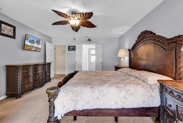 bedroom featuring light carpet, a ceiling fan, and baseboards