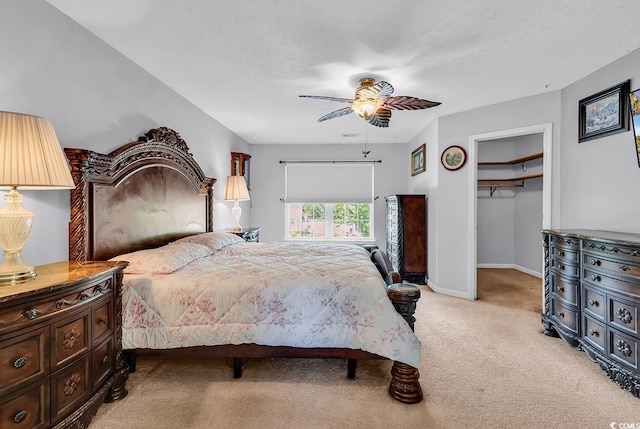 bedroom featuring light colored carpet, a closet, ceiling fan, and baseboards