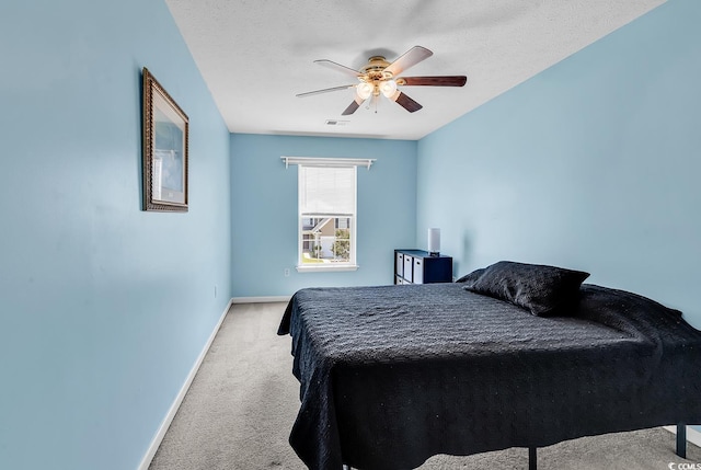 carpeted bedroom with baseboards and a ceiling fan