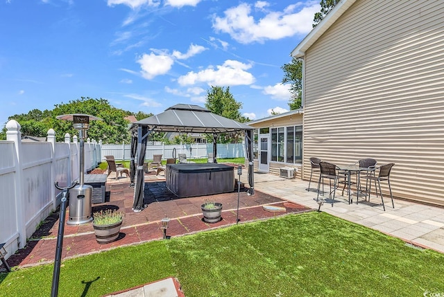 view of yard with a hot tub, a gazebo, and a patio
