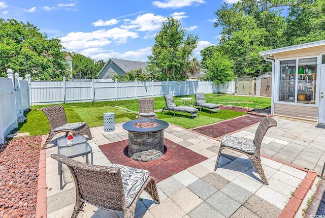 view of patio / terrace with an outdoor fire pit, a storage shed, and an outdoor structure