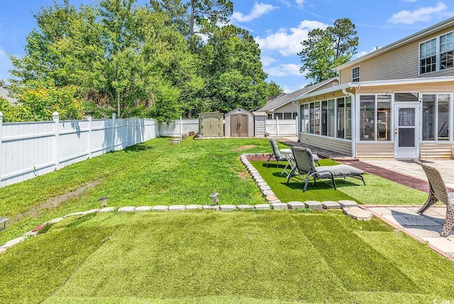 view of yard featuring a sunroom, a storage shed, and an outdoor structure