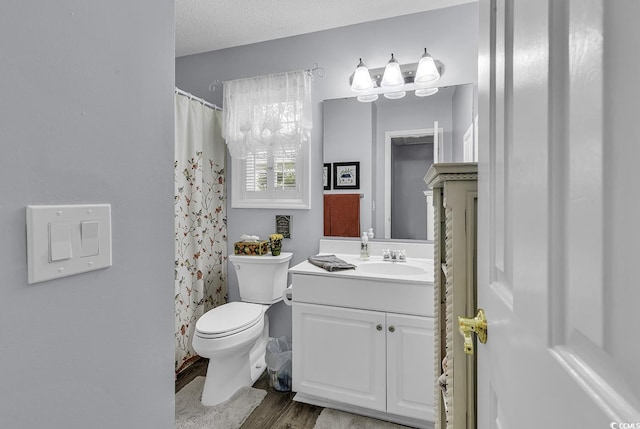 bathroom with vanity, toilet, wood finished floors, and a shower with curtain