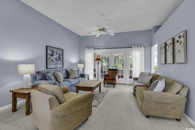 living room featuring french doors, light colored carpet, baseboards, and ceiling fan
