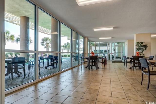 common area featuring floor to ceiling windows and a textured ceiling