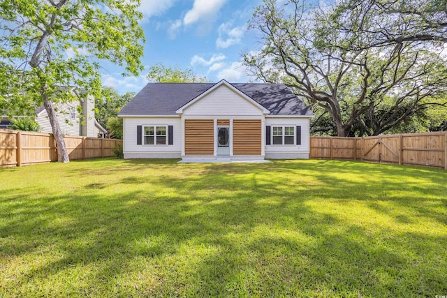 back of house with a shingled roof