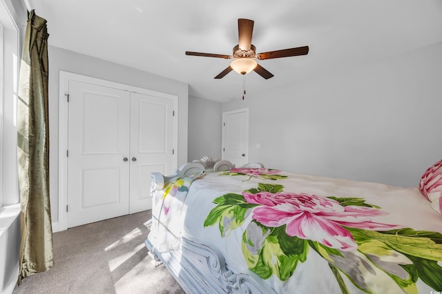 carpeted bedroom with a closet and ceiling fan