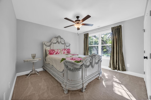 carpeted bedroom featuring baseboards and ceiling fan