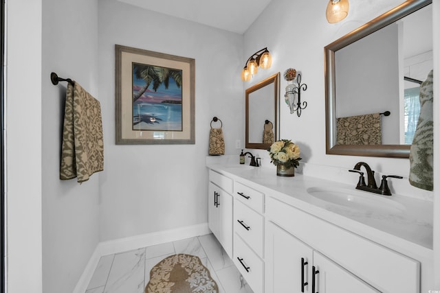 full bathroom with marble look tile flooring, baseboards, and double vanity