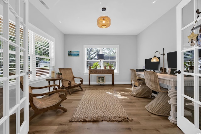 home office with plenty of natural light, french doors, and wood finished floors