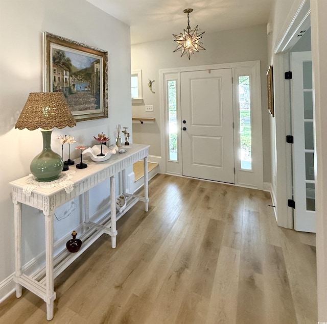 foyer entrance with light wood finished floors and baseboards