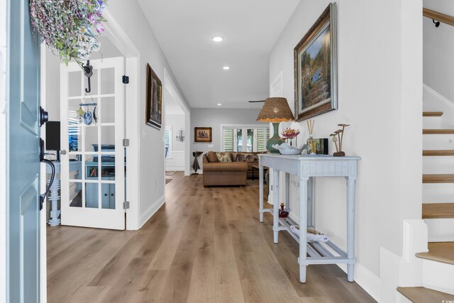 corridor with wood finished floors, recessed lighting, and baseboards