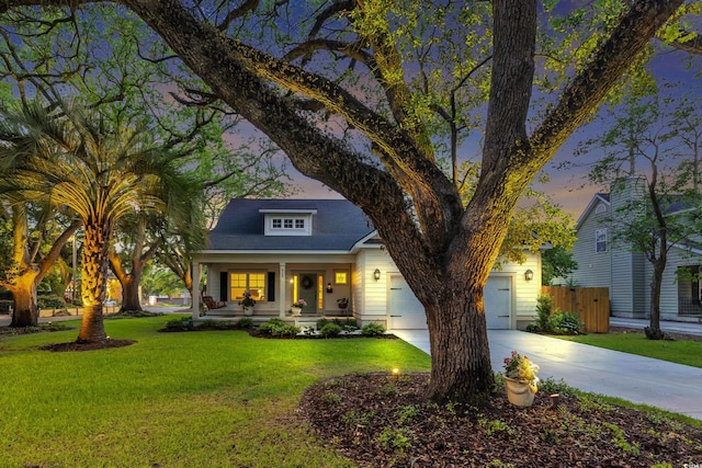 view of front of house with covered porch, concrete driveway, and a garage