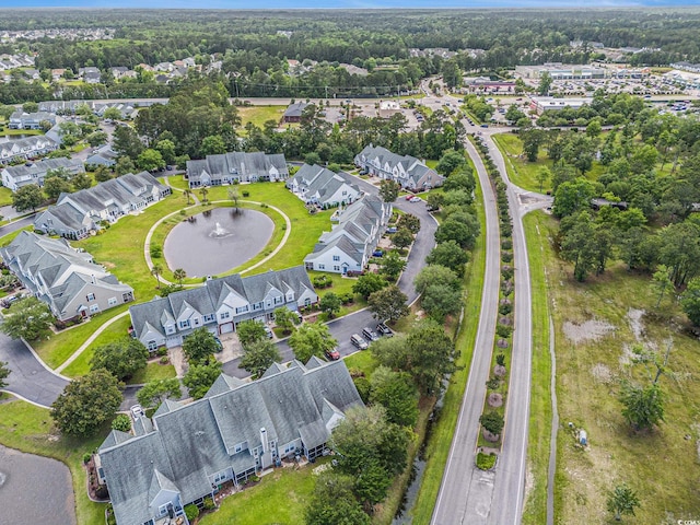 aerial view of property and surrounding area with nearby suburban area and a nearby body of water