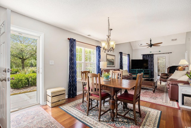 dining space featuring a chandelier, wood finished floors, a textured ceiling, and a ceiling fan
