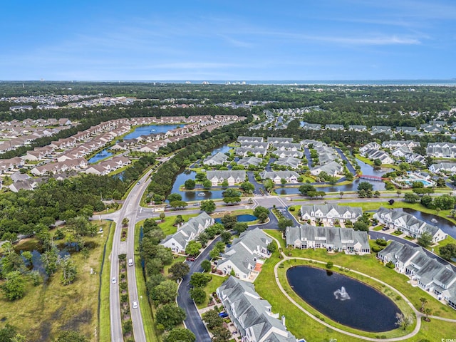 aerial view of property's location with nearby suburban area and a nearby body of water
