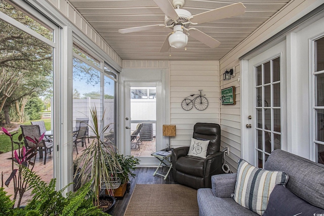 sunroom / solarium featuring ceiling fan