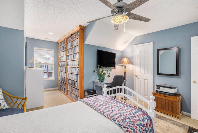 carpeted bedroom with baseboards, a textured ceiling, and a ceiling fan