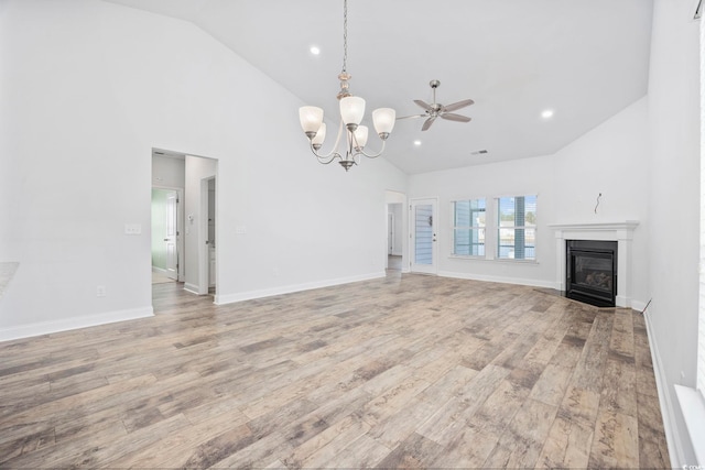 692 Cherry Blossom Dr, Murrells Inlet, SC 29576 - unfurnished living room featuring high vaulted ceiling, light wood finished floors, a glass covered fireplace, a chandelier, and recessed lighting