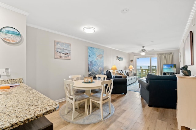 1310 N Waccamaw Dr Unit 204, Garden City Beach, SC 29576 - dining space featuring crown molding, light wood-style floors, ceiling fan, and baseboards