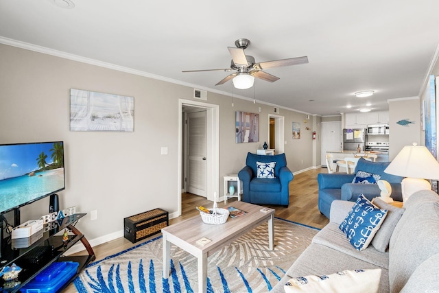 1310 N Waccamaw Dr Unit 204, Garden City Beach, SC 29576 - living area with light wood-style flooring, a ceiling fan, baseboards, and crown molding