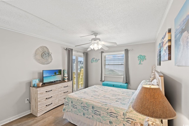 1310 N Waccamaw Dr Unit 204, Garden City Beach, SC 29576 - bedroom featuring wood finished floors, a textured ceiling, ornamental molding, a ceiling fan, and access to outside