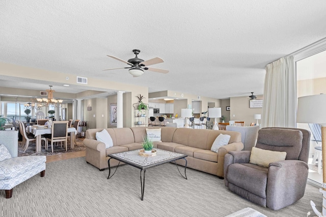 3805 S Ocean Blvd # 503, North Myrtle Beach, SC 29582 - living room featuring ceiling fan, a textured ceiling, a chandelier, and decorative columns