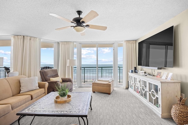 3805 S Ocean Blvd # 503, North Myrtle Beach, SC 29582 - carpeted living room with floor to ceiling windows, a textured ceiling, and a ceiling fan