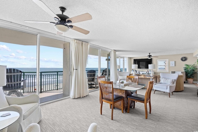 3805 S Ocean Blvd # 503, North Myrtle Beach, SC 29582 - dining area featuring a ceiling fan, a water view, a textured ceiling, carpet flooring, and floor to ceiling windows