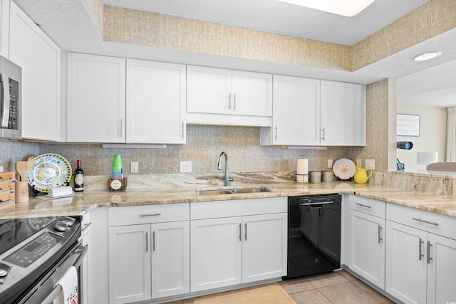 3805 S Ocean Blvd # 503, North Myrtle Beach, SC 29582 - kitchen with appliances with stainless steel finishes, a sink, white cabinets, backsplash, and a textured ceiling