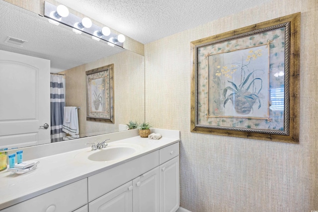 3805 S Ocean Blvd # 503, North Myrtle Beach, SC 29582 - full bathroom with vanity, a textured ceiling, and wallpapered walls