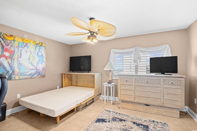3805 S Ocean Blvd # 503, North Myrtle Beach, SC 29582 - bedroom featuring tile patterned flooring, a ceiling fan, baseboards, and a textured ceiling