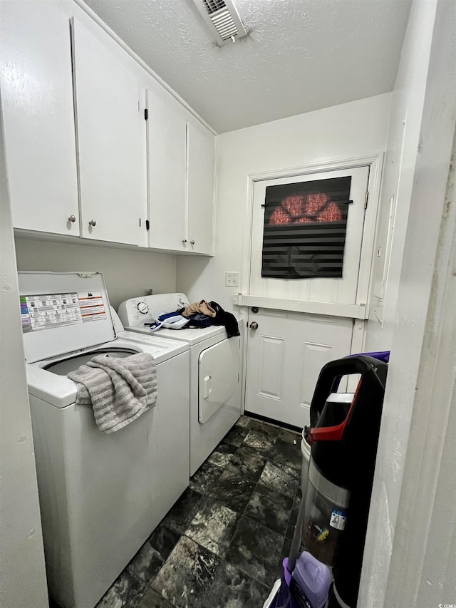 755 Burcale Rd Unit G4, Myrtle Beach, SC 29579 - clothes washing area with washing machine and clothes dryer, cabinet space, and a textured ceiling