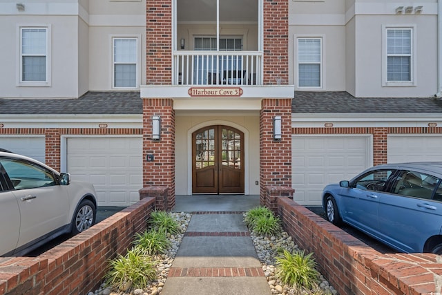 2241 Waterview Dr Unit 537, North Myrtle Beach, SC 29582 - property entrance with an attached garage, brick siding, a shingled roof, french doors, and stucco siding