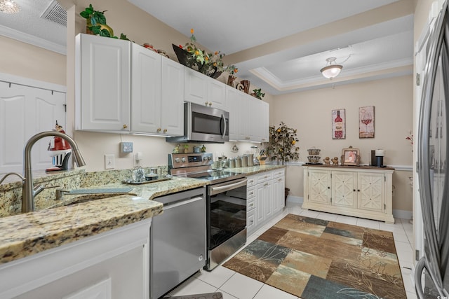 2241 Waterview Dr Unit 537, North Myrtle Beach, SC 29582 - kitchen with stainless steel appliances, light tile patterned flooring, ornamental molding, light stone counters, and white cabinets