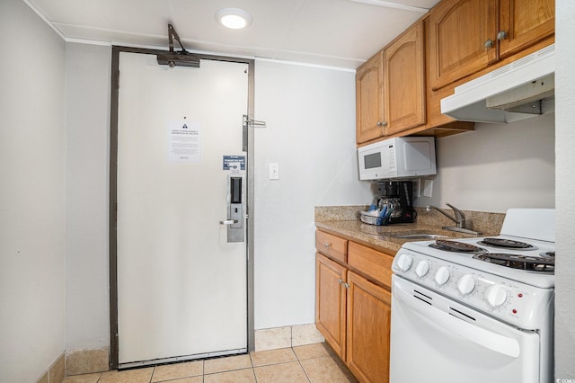 7100 N Ocean Blvd N Unit 1011, Myrtle Beach, SC 29572 - kitchen featuring white appliances, under cabinet range hood, a sink, light tile patterned flooring, and brown cabinetry